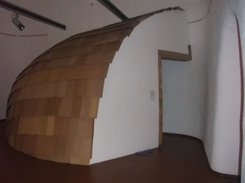 The roof and curved wall is covered in cardboard