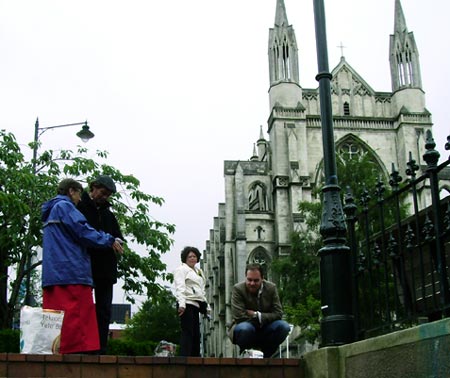 Sonja herds elephants from the Robbie Burns statue through past the OCCUPY Dunedin tents and onto the street in the Octagon in Dunedin.