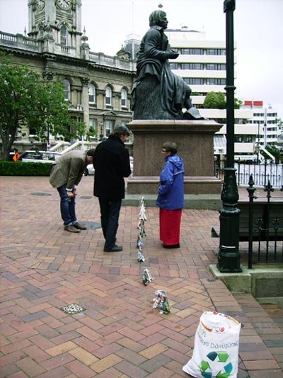 Sonja herds elephants from the Robbie Burns statue through past the OCCUPY Dunedin tents and onto the street in the Octagon in Dunedin.