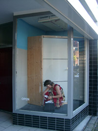 Performance in a shop window, Aalmarkt, Leiden, The Netherlands.