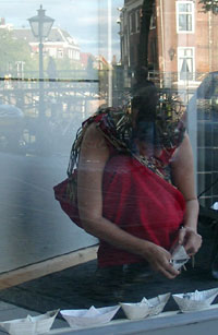 Performance in a shop window, Aalmarkt, Leiden, The Netherlands.